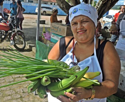 Woman in Brazil holding food crops