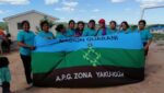 Indigenous Guarani women in Bolivia holding a banner
