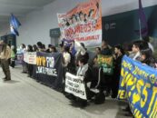 Climate justice activists at COP29 holding banners