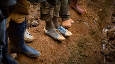 People in Goma DRC standing on eroded soil near a mine