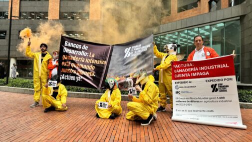 Demonstrators holding banners outside the World Bank offices in Bogota, Colombia