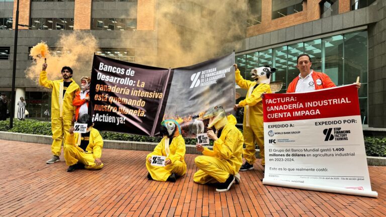 Demonstrators holding banners outside the World Bank offices in Bogota, Colombia